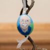 A Pol farm peahen egg painted with a picture of Dr. Pol in a blue shirt