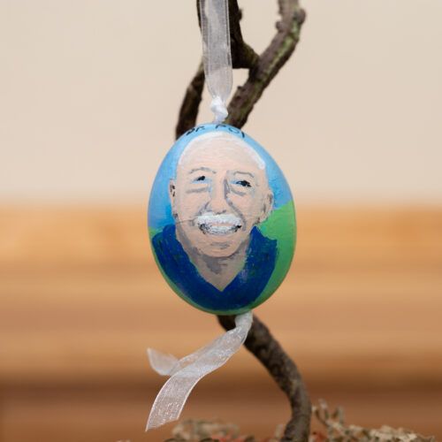 A Pol farm peahen egg painted with a picture of Dr. Pol in a blue shirt